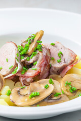 veal roll in bacon with mushroom sauce and potatoes