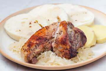 pork meat on cumin with cabbage and dumplings