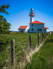 Fototapeta na wymiar View on the Pointe Mitis lighthouse on a sunny morning (Located in the province of Quebec, Canada)