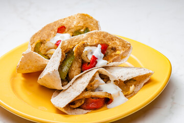wholewheat  pitta bread filled with grilled chicken meat, jalapenos and red pepper