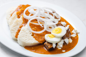 beef goulash with onion rings, boiled egg and dumplings