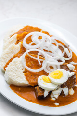 beef goulash with onion rings, boiled egg and dumplings