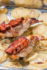 rabbit legs baked with bacon on onion rings