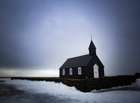 Black wooden church during winter, Iceland