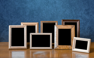 frames on table, blue wall