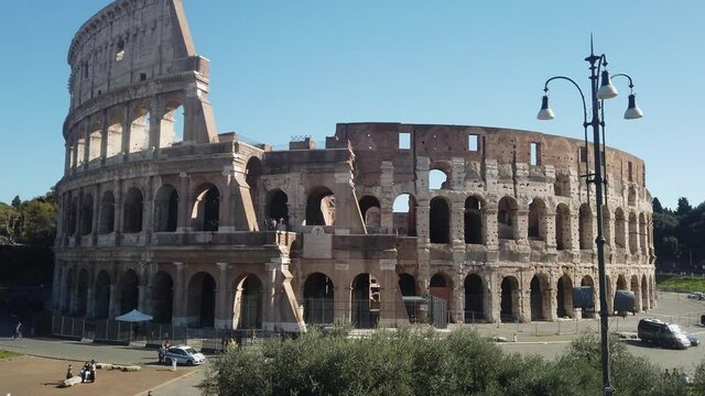 Sunlit interior and exterior walls of Roman Colosseum still standing