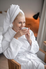 A pretty woman resting after the shower and looking happy