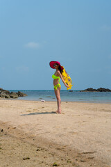 Fototapeta na wymiar Portrait of thai woman posing outdoors at the sea beach