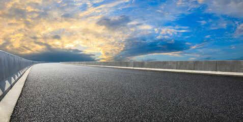Asphalt highway and beautiful sky cloud scenery at sunset.
