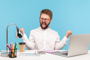 Extremely positive satisfied man office worker showing tongue out making yes gesture, happy excited...