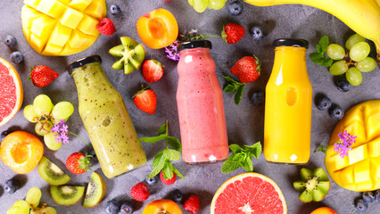 fruit smoothie in bottle and fresh fruits
