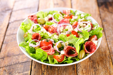 vegetable salad with salami,  tomato and cheese