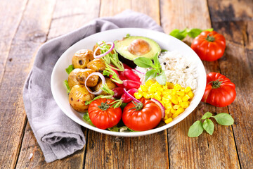 buddha bowl- salad with potato, avocado, tomato, radish and rice
