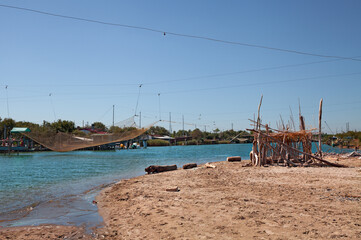 Ravenna, Emilia Romagna, Italy: landscape of the river mouth Fiumi Uniti with fishing huts and nets