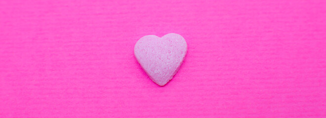 Pink heart on pink background. Saint Valentine's day concept. Love and romantic photo. Postcard for holiday. Beautiful warm wallpaper with love. Soft focus. Copy space.