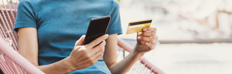 Woman using smartphone with credit card making online payment. Business, online shopping, e-commerce, internet banking, spending money, travel, vacations concept