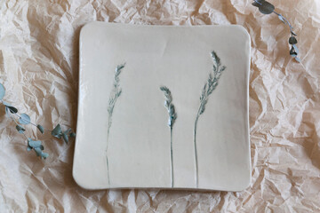 Ceramic square plate with plant print close-up