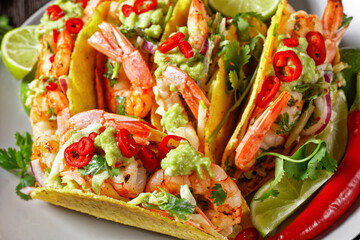 taco shells with shrimps on a plate