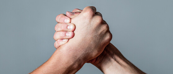 Arms wrestling. Closep up. Friendly handshake, friends greeting, teamwork, friendship. Handshake,...