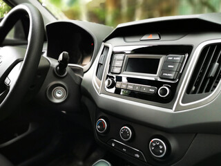 Close-up of Man Hands, car control panel. Steering wheel while driving a car