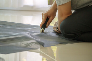 Obraz premium man install mosquito net wire screen on house window protection against insect