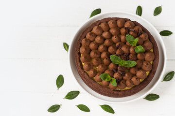 Chocolate tart with  fresh mint leaves. Chocolate pie, Chocolate cake. White background