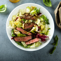 Healthy green salad with grilled beef steak