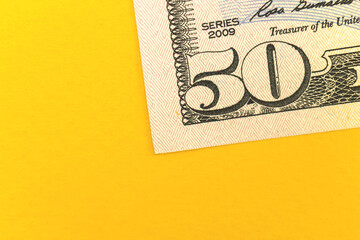 Deposit money with fifty dollar bills, office desktop with yellow background and copy space photo
