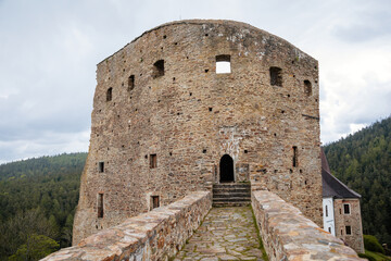 Gothic medieval castle Velhartice in sunny day, tower and stone arch bridge, fortress masonry wall, old stronghold, Velhartice, National Park Sumava, South Bohemia, Czech Republic