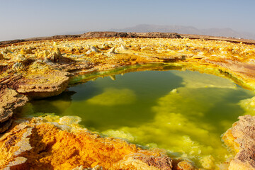Acid yellow-​green pool, and eggshell-like ground that ejects poisonous gas. In Dallol, the Danakil Depression, Ethiopia