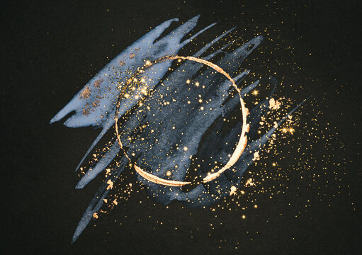 Glitter on abstract golden and blue watercolor stains on black background, frame for your design
