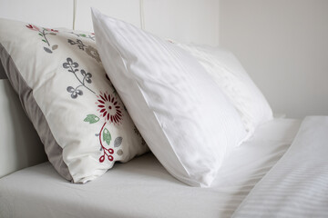 clean white pillows on bed