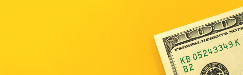 Finance investment concept, banner with money US one hundred dollar bill on a yellow background with copy space, top view photo