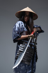 Female samurai with sword and bamboo hat