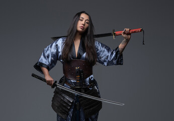 Dangerous woman samurai posing with samurai swords
