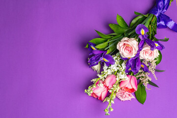 A beautiful bouquet of fresh flowers on a lilac pastel background