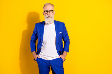 Photo portrait of confident man wearing blue suit glasses isolated bright yellow color background