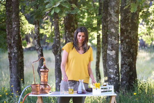 Woman working on natural cosmetics in the forest