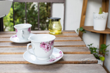 bright small apartment terrace in summer with flowers and coffee table