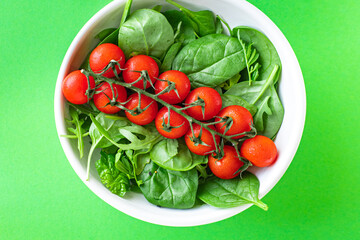fresh vegetable salad tomato cherry veggie green leaves mix greens spinach, arugula, lettuce ingredient on the table healthy food meal copy space food background 