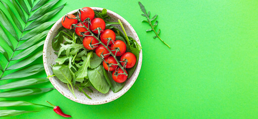 fresh vegetable salad tomato cherry veggie green leaves mix greens spinach, arugula, lettuce ingredient on the table healthy food meal copy space food background 