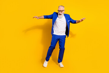 Full length body size view of attractive imposing funky cheerful man dancing isolated over bright yellow color background