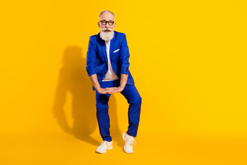 Full length portrait of excited cheerful person partying enjoy free time vacation isolated on yellow color background