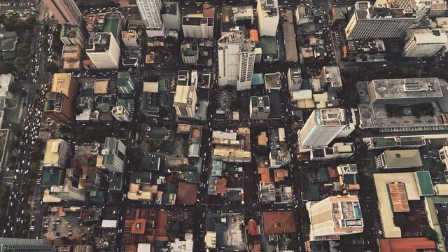 Aerial top down view of city center downtown buildings. Asia business cityscape. Drone flight over roofs and streets with cars driving roads. Cinematic metropolis scenery at summer day.