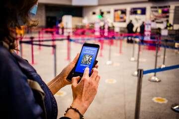 health Vaccine Passport for Coronavirus or Covid-19. Traveller Using Mobile Phone with Vaccination in Immune Status to Certificated International Traveling in Airport