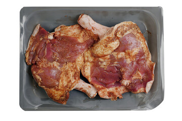 Two fresh uncooked duck legs on a grey plastic tray. Poultry product. Isolated on white background.
