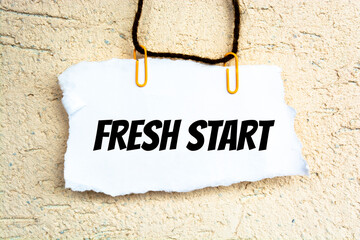 text FRESH START on the short note texture background with pen. Business concept