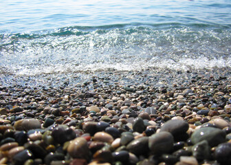 photo of pebble beach and sea with wave
