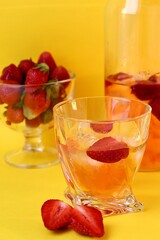 fruit juice or summers drink in glass and strawberries