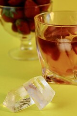 glass of champagne with ice and strawberries